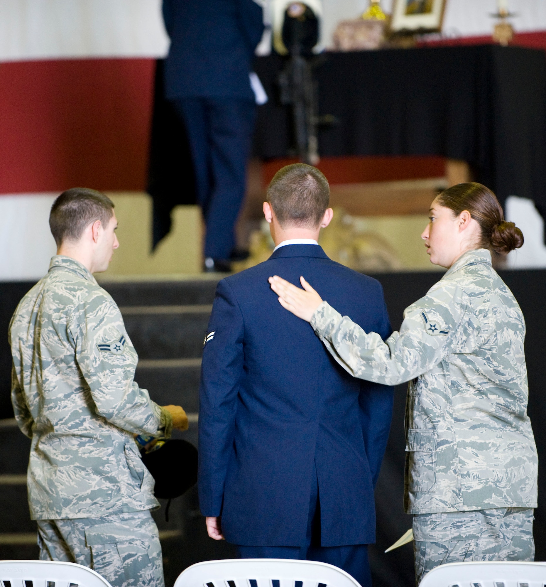 Members of the 39th Security Forces Squadron comfort each other during the memorial service for Airman 1st Class Floyd Glover April 25, 2012, at Incirlik Air Base, Turkey. The ceremony honored the life of Glover, a member of the 39th SFS Avenger Flight who died April 22. (U.S. Air Force photo by Senior Airman Clayton Lenhardt/Released)