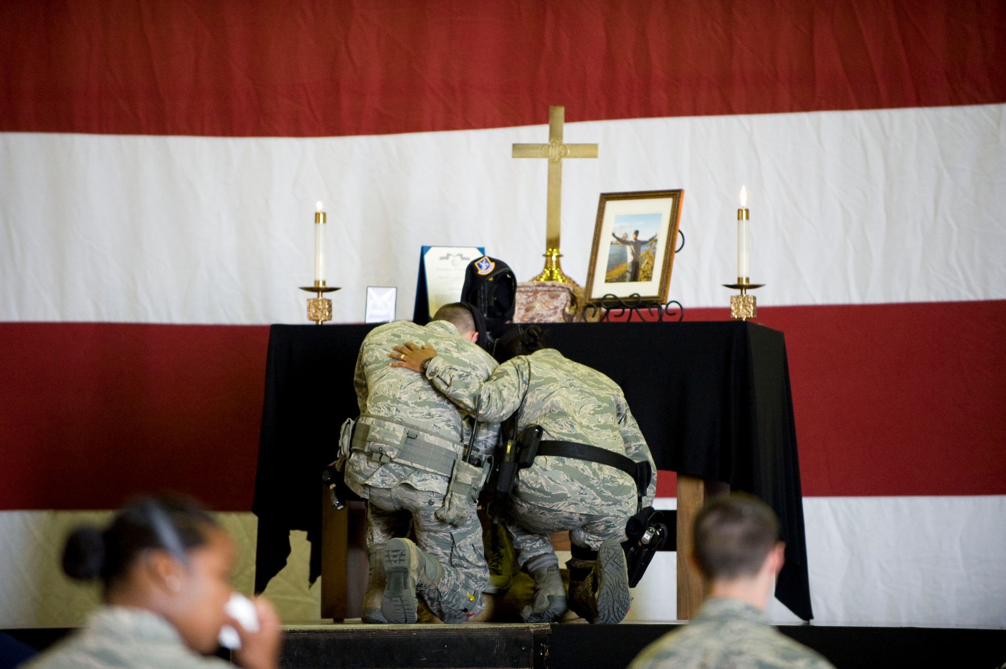Members of the 39th Security Forces Squadron kneel in respect during the memorial service for Airman 1st Class Floyd Glover April 25, 2012, at Incirlik Air Base, Turkey. The ceremony honored the life of Glover, a member of the 39th SFS Avenger Flight who died April 22. (U.S. Air Force photo by Senior Airman Clayton Lenhardt/Released)