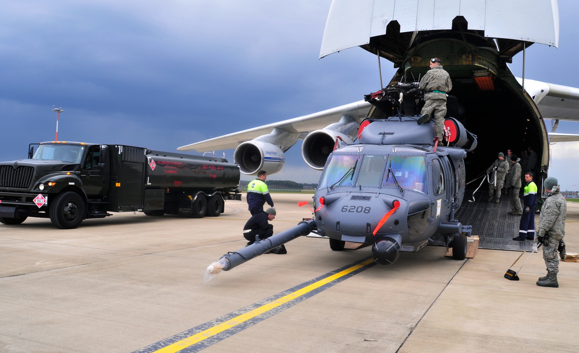 ROYAL AIR FORCE LAKENHEATH, England - Airmen of the 48th Fighter Wing and Russian civilian aircrew members work together to unload an HH-60 Pave Hawk from an AN-124 Antonov, a civilian Russian transport carrier, on the flightline April 20, 2012. The helicopter was being returned to RAF Lakenheath after undergoing Joint Depot Level Maintenance at Korean Airlines Limited for eight months. All aircraft undergo this process every 72 months to extend the life of the 56th Rescue Squadron's fleet. (U.S. Air Force photo by Senior Airman Tiffany M. Deuel) 