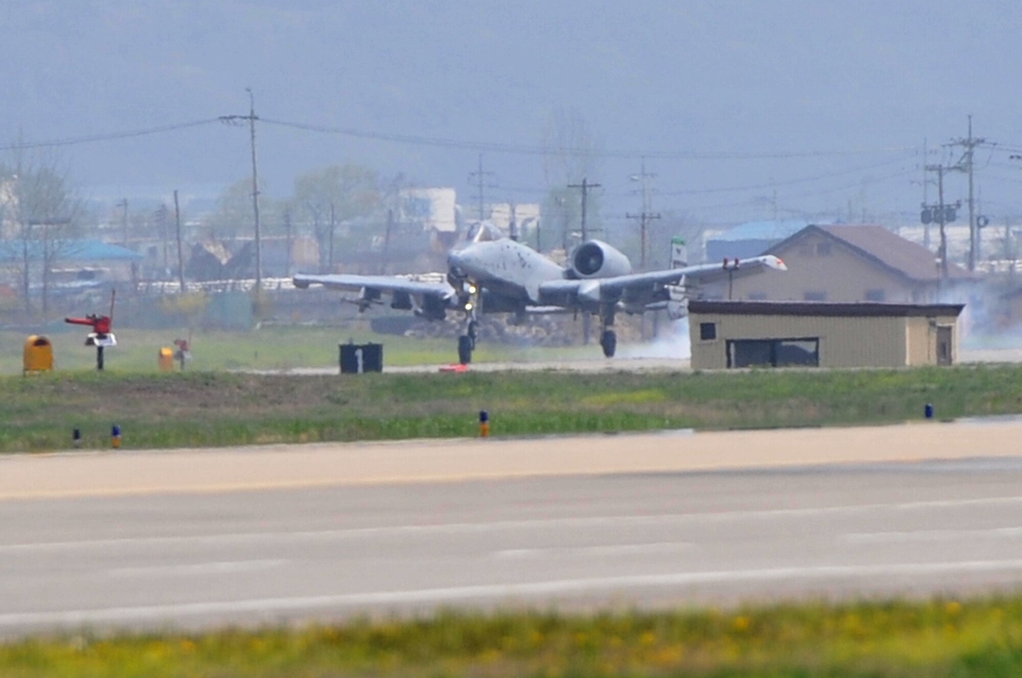 The first A-10 Thunderbolt II sortie for operational readiness exercise Beverly Midnight 12-02 lands on the Osan Air Base flight line, April 24, 2012. Beverly Midnight 12-02 is the second half of a two-week consolidated unit inspection where Osan Air Base Exercise Evaluation Team members are graded by Pacific Air Force inspectors on how well they conduct an ORE. Osan’s Airmen provide combat ready forces for close air support, air strike control, counter air, interdiction, theater airlift, and communications in the defense of the Republic of Korea, and the ORE tests these abilities during a heightened state of readiness. (U.S. Air Force photo/Staff Sgt. Stefanie Torres)