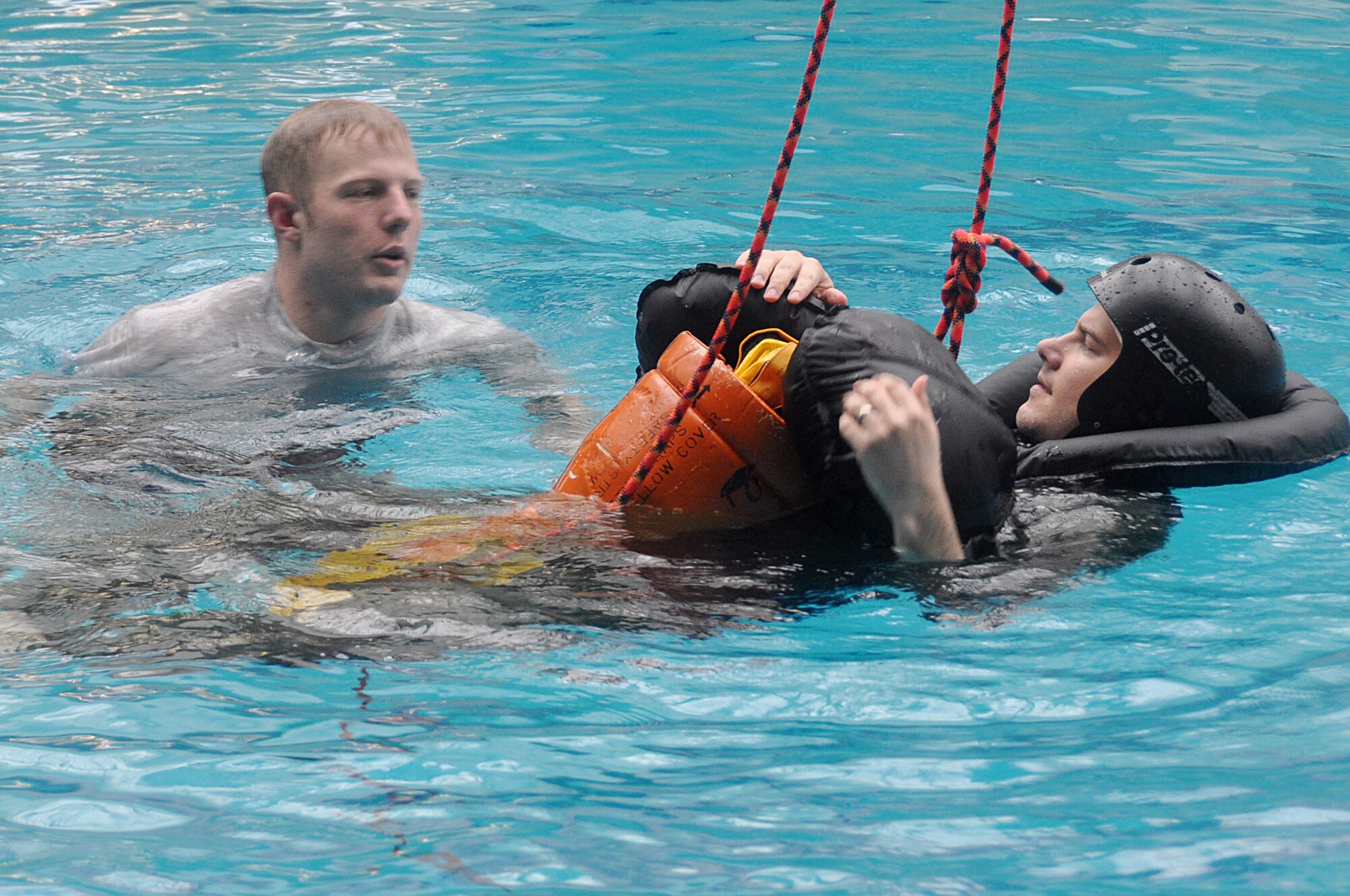 Staff Sgt. David Kummerfeldt, 51st Operations Support Squadron Survival, Escape, Resistance and Escape instructor, gives Capt. Brent Choate helpful tips to remember during water survival training here, April 23, 2012. Choate is a pilot with the 36th Fighter Squadron. (U.S. Air Force photo/Staff Sgt. Stefanie Torres)