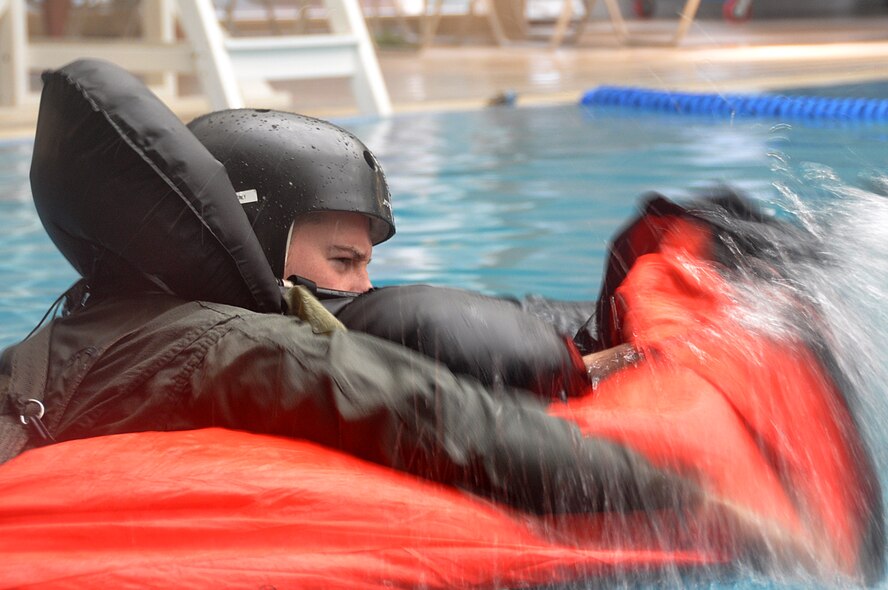 Capt. Brent Choate, 36th Fighter Squadron pilot, lifts himself into his life raft during water survival training at Osan Air Base, Republic of Korea, April 23, 2012. Osan’s Survival, Evasion, Resistance and Escape instructors provide realistic training for pilots who may have to eject over open water. (U.S. Air Force photo/Staff Sgt. Stefanie Torres) 
