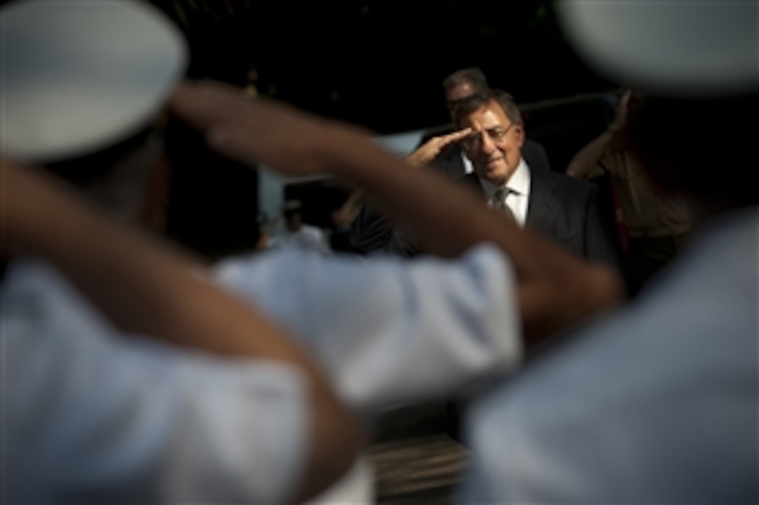 Secretary of Defense Leon E. Panetta returns a salute during departure honors after visiting Governor's Island Marine Base, Rio de Janeiro, Brazil, April 25, 2012. Panetta is on a five-day trip to the region to meet with counterparts and military officials in Brazil, Colombia and Chile to discuss an expansion of defense and security cooperation.  