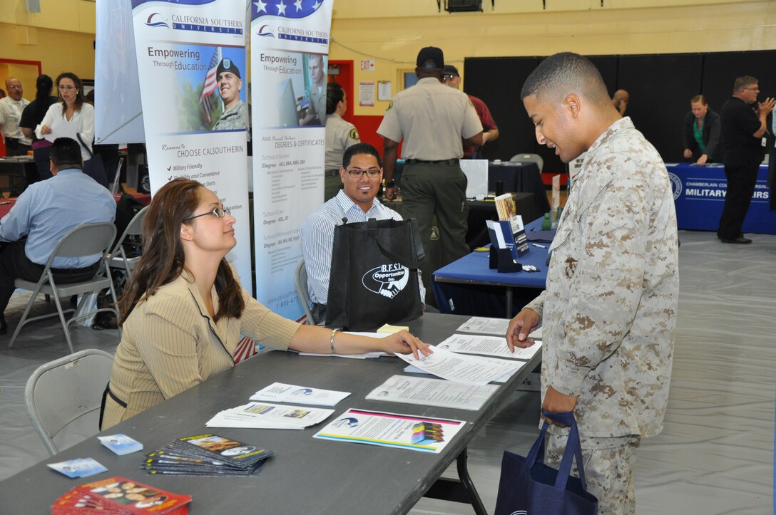Lance Cpl. Andre Nelson, system administrator aboard base, discusses the programs that Barstow Employment Specialized Training Opportunities offers with Karin Etheridge, CEO of B.E.S.T. Opportunities, during the Career and Education Expo aboard Marine Corps Logistics Base Barstow, April 26. The expo was held to help Marines and employees a chance to learn about furthering their education as well as potential employment opportunities.::r::::n::