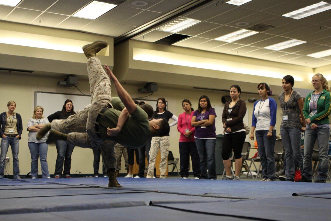Two Marines perform a sweeping hip throw at the Marine Corps Air Station Camp Pendleton's Mary Munn Day, April 27. The attending Marine Wives learned a few basic Marine Corps Martial Arts Program techniques after orientation.