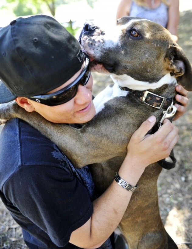 After changing out of his formals, U.S. Marine Lance Cpl Jonathan Contreras, from Vista, Calif. gets lots of hugs and kisses from his two-year-old pit bull Diego after a seven month absence, at Uvas Reservoir Sunday. While Contreras was on deployment in Afghanistan, Diego's living situation was facilitated through a national organization called Dogs on Deployment, where he has been staying at a Gilroy home for the past three months.