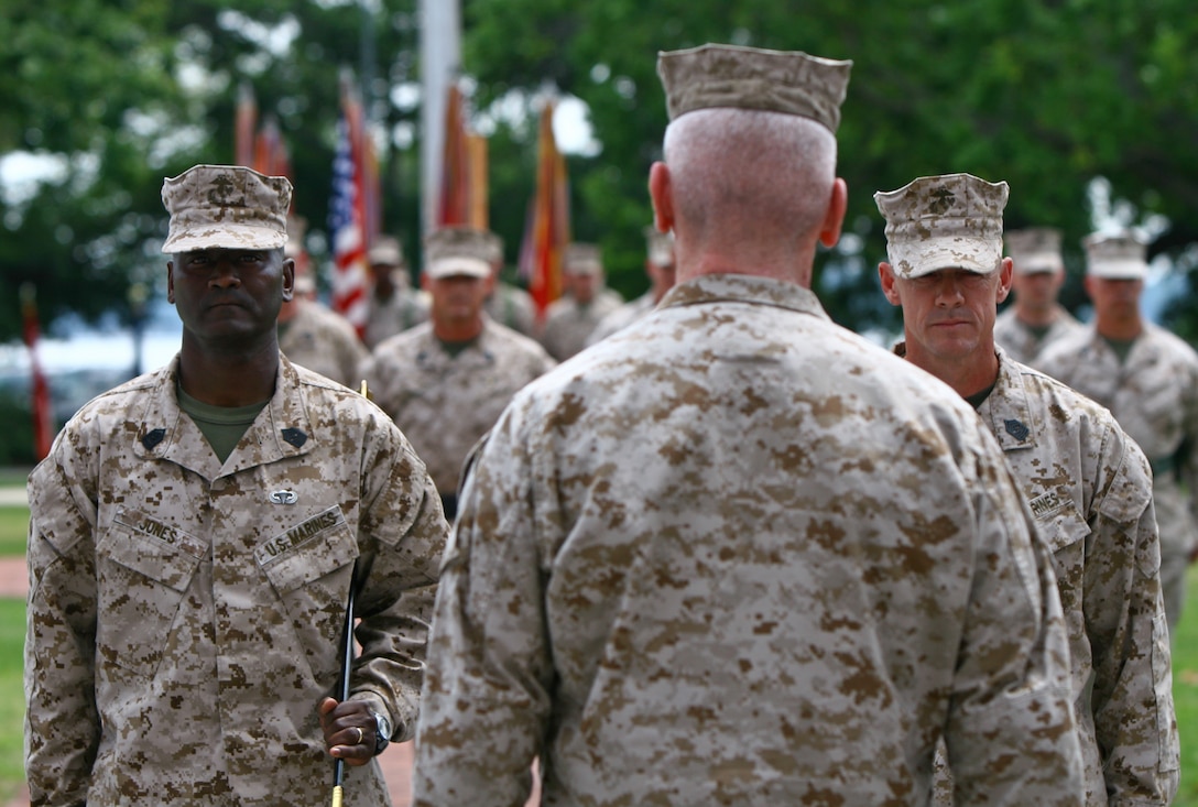 Clinton, N.C., native Sgt. Maj. Michael F. Jones (left) and Omaha, Neb., native Sgt. Maj.  Bryan K. Zickefoose (right) stand before Major Gen. John A. Toolan Jr., commanding general of the 2nd Marine Division and a Brooklyn, N.Y., native, during the division’s Relief and Appointment ceremony April 27.  During the ceremony, Zickefoose replaced Jones as sergeant major of the division and Jones received the Legion of Merit.  The Legion of Merit is presented to those who have distinguished themselves through exceptionally meritorious conduct in the performance of outstanding service.  (Official U.S. Marine Corps photo by Cpl. Tommy Bellegarde)