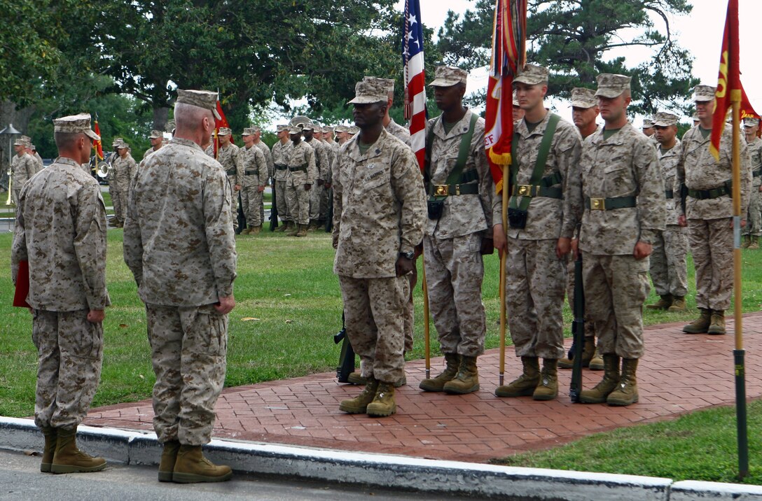 Clinton, N.C., native Sgt. Maj. Michael F. Jones (center), takes his place to receive the Legion of Merit April 27 during the 2nd Marine Division Relief and Appointment ceremony.  Major Gen. John A. Toolan Jr. (second from left), commanding general of the division and a Brooklyn, N.Y., native, presented the award during the ceremony in which Omaha, Neb., native Sgt. Maj. Bryan K. Zickefoose (left) replaced Jones as the sergeant major of 2nd Marine Division. The Legion of Merit is presented to those who have distinguished themselves through exceptionally meritorious conduct in the performance of outstanding service. (Official U.S. Marine Corps photo by Cpl. Tommy Bellegarde)