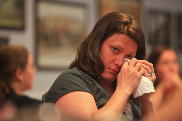 Vanessa Jarr, the wife of a Marine with Combat Logistics Battalion 2, 2nd Marine Logistics Group, wipes away tears during a particularly emotional discussion at a Cheers, Tears and Fears event led by the unit’s Family Readiness Officers aboard Camp Lejeune, N.C., April 26, 2012.  Jarr and other spouses in attendance spoke about communication issues, community involvement and deployment preparation.  (U.S. Marine Corps photo by Cpl. Katherine M. Solano)