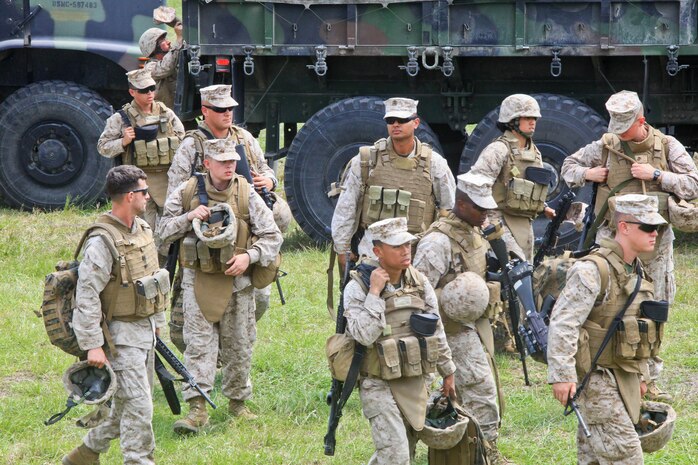 Marines with Combat Logistics Battalion 2, 2nd Marine Logistics Group dismount tactical vehicles after a simulated convoy aboard Camp Lejeune, N.C., April 27, 2012.  The convoy took place at a battalion field exercise, during which other simulations, scenarios and training exercises were conducted.  (U.S. Marine Corps photo by Cpl. Katherine M. Solano)