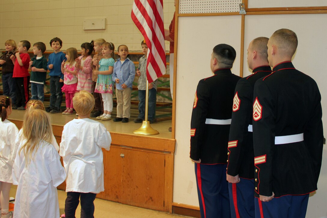 Recruiters from the Roseville, Minn., office lead children in the Pledge of Allegiance at Christ Lutheran School April 27 during a Grandparents' Day recognition ceremony. A group of five-year-olds, including Staff Sgt. Jowa Wildes' son, recited the pledge in sign language. Nearly half of the ceremony attendees served in at least one branch of the armed forced.