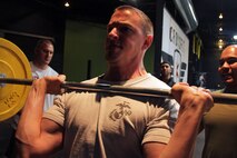 Fargo, N.D., recruiter Staff Sgt. Dale Servold, 26, from Sioux Falls, S.D., demonstrates a push-press exercise to his fellow Marines during a CrossFit re-certification course April 27. For additional imagery from the event, visit www.facebook.com/rstwincities.
