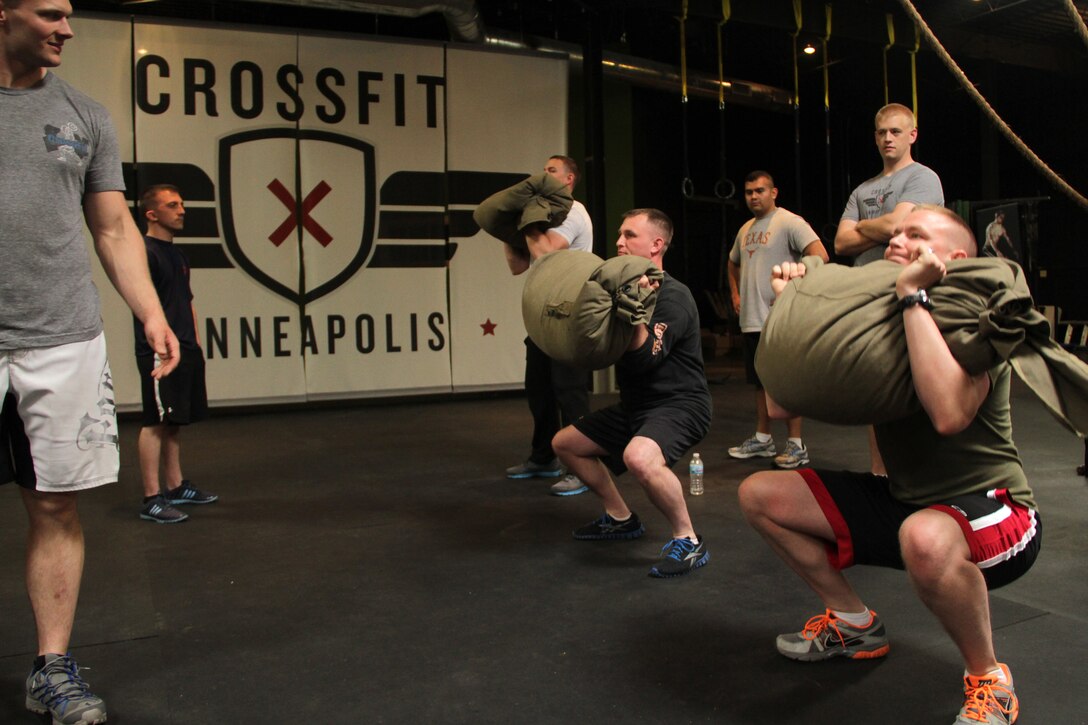 Rob Gerdes, former ground intelligence officer with 3rd Reconnaissance Battalion, watches Marines with Recruiting Station Twin Cities conduct seabag cleans during a CrossFit re-certification course April 27. For additional imagery from the event, visit www.facebook.com/rstwincities.