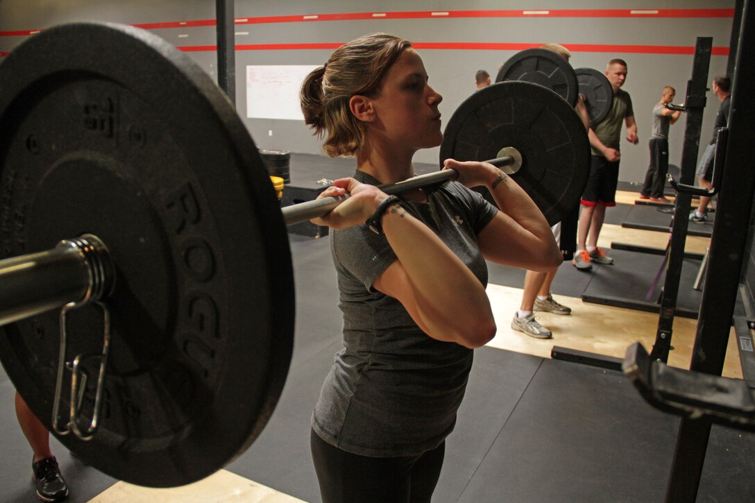 Burnsville, Minn., recruiter Sgt. Rebecca Carlson, 22, from Hastings, Minn., performs push-press exercises during a CrossFit re-certification course April 27. For additional imagery from the event, visit www.facebook.com/rstwincities.