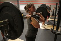Burnsville, Minn., recruiter Sgt. Rebecca Carlson, 22, from Hastings, Minn., performs push-press exercises during a CrossFit re-certification course April 27. For additional imagery from the event, visit www.facebook.com/rstwincities.