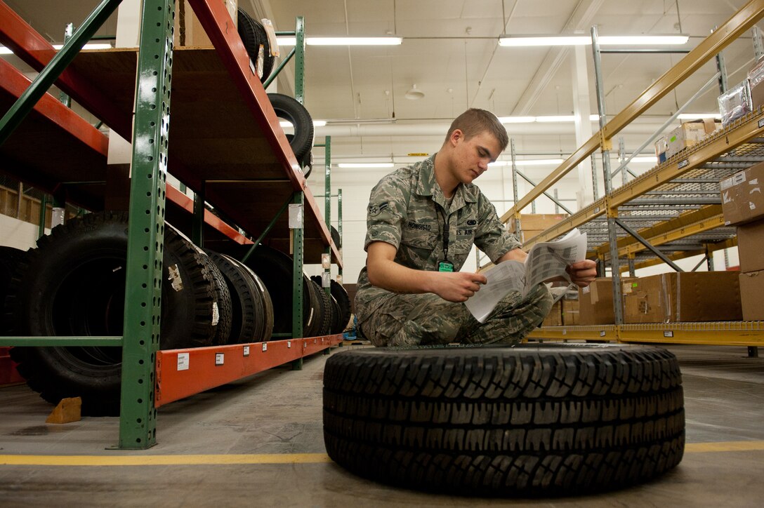 Airman 1st Class Adam Hongisto, 28th Logistics Readiness Squadron central storage technician, verifies the expiration date of a tire in the storage and issue facility at Ellsworth Air Force Base, S.D., April 25, 2012. Double-checking the expiration dates of tires improves safety for Ellsworth’s vehicle operators. (U.S. Air Force photo by Airman 1st Class Kate Thornton/Released)  