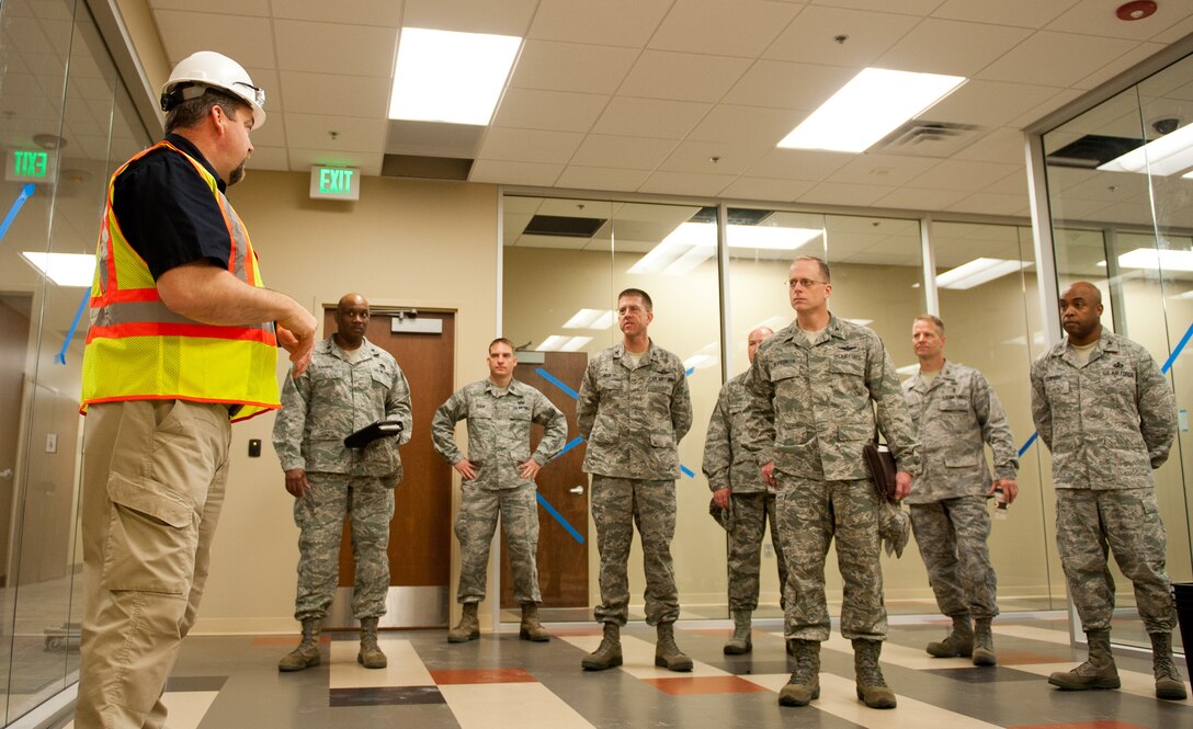 28th Bomb Wing leadership admire the features of the new deployment center at Ellsworth Air Force Base, S.D., during a tour, April 25, 2012. This section of the personnel deployment function line will include kiosks to streamline the process of entering and verifying important information. (U.S. Air Force photo by Airman 1st Class Kate Thornton/Released)