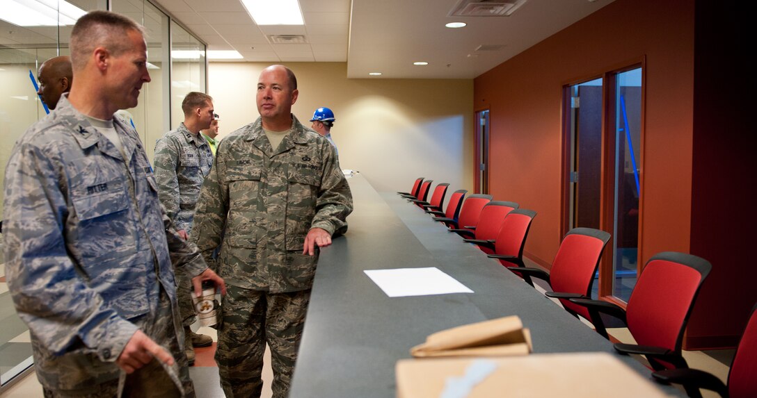 28th Bomb Wing leadership views the soon-to-be personnel deployment function area during a tour of the new deployment center at Ellsworth Air Force Base, S.D., April 25, 2012. The new PDF line will allow for faster and more accurate processing by providing the PDF Airmen access to their computer based files. (U.S. Air Force photo by Airman 1st Class Kate Thornton/Released)