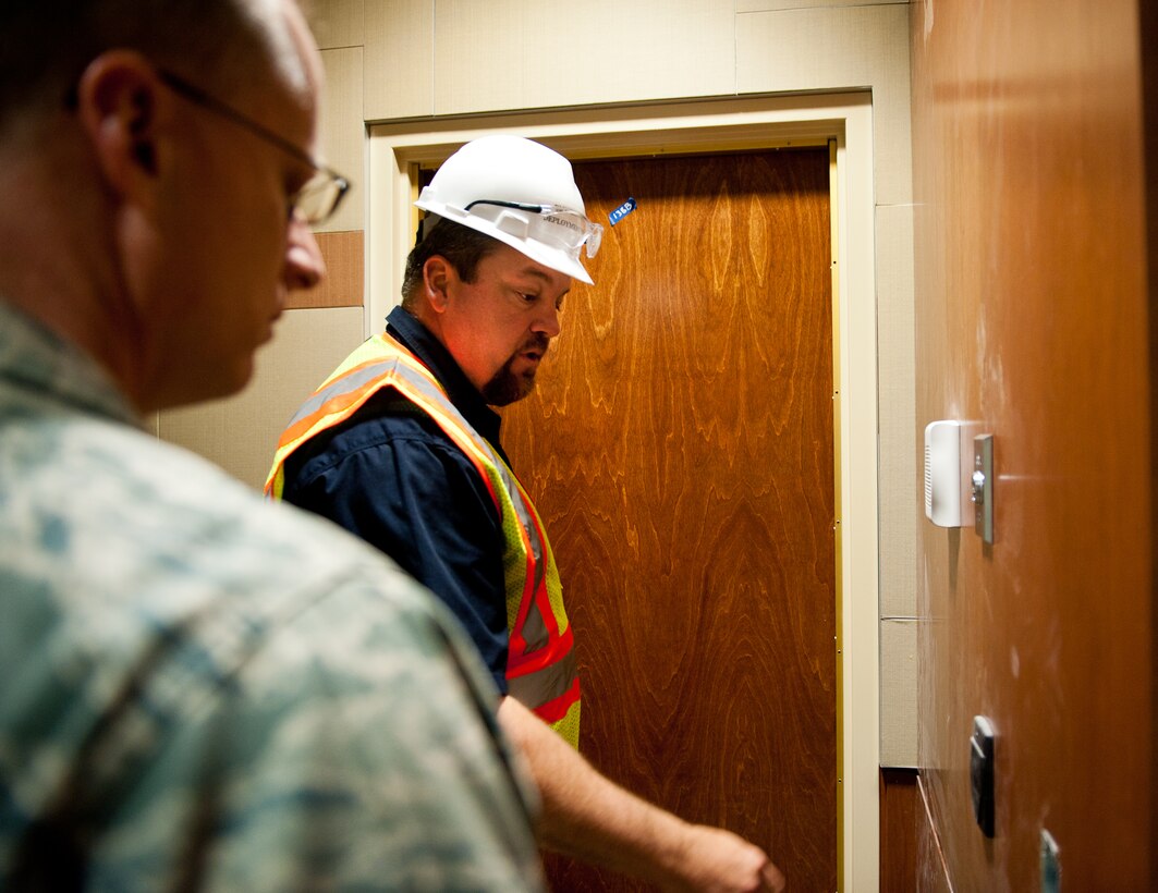 Rick Schroder, 28th Logistics Readiness Squadron installation deployment officer, explains some security features to Col. Mark Weatherington, 28th Bomb Wing commander, during a tour of the new deployment center at Ellsworth Air Force Base, S.D., April 25, 2012. The new deployment center will feature different upgrades intended to streamline processes and make regular procedures more efficient. (U.S. Air Force photo by Airman 1st Class Kate Thornton/Released)