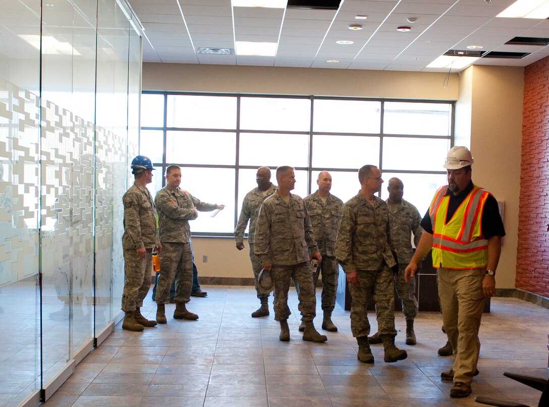28th Bomb Wing leadership discuss features of the Transportation Safety Administration area during a tour of the new deployment center currently under construction at Ellsworth Air Force Base, S.D., April 25, 2012. The upgraded center will be a multi-use facility to host several operations including deployment processing, training  and the base’s upcoming 70th Anniversary Kick-off Celebration. (U.S. Air Force photo by Airman 1st Class Kate Thornton/Released) 