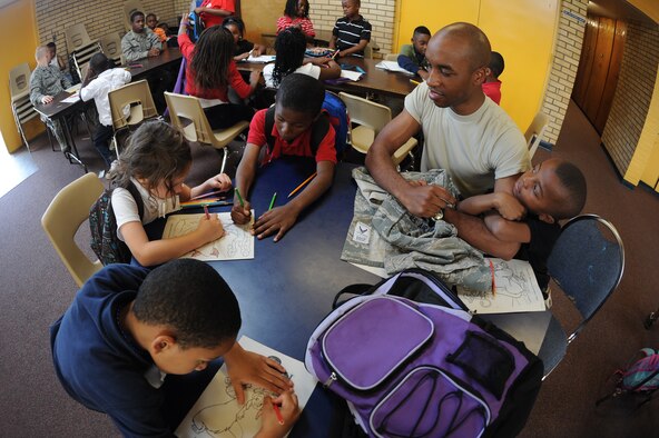 U.S. Air Force Senior Airman Myron Saunders observes children color at the Boys and Girls Club in Goldsboro, N.C., April 26, 2012. Airmen from the 4th Fighter Wing volunteered to help strengthen the Boys and Girls Club’s core beliefs of providing a safe place to learn and grow to enable all young people to reach their full potential as productive, caring and responsible citizens. Saunders, 4th Civil Engineering Squadron emergency manager, is from High Point, N.C. (U.S. Air Force photo/Airman 1st Class John Nieves Camacho/Released)