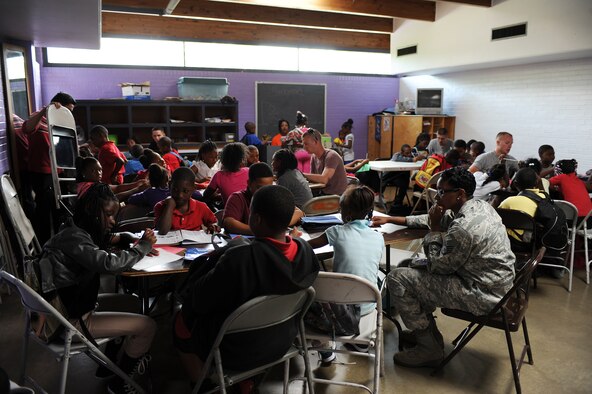 Airmen from the 4th Fighter Wing interact with children at the Boys and Girls Club in Goldsboro, N.C., April 26, 2012. The Airmen volunteered during their off time to be mentors for children by helping with their homework and hanging out. (U.S. Air Force photo/Airman 1st Class John Nieves Camacho/Released)