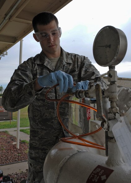 U.S. Air Force Airman Noah Lazurka collects a fuel sample from a pipeline on Seymour Johnson Air Force Base, N.C., April 25, 2012. On average 260,000 gallons of fuel are used daily for F-15E Strike Eagles and KC-135R Stratotankers stationed here. Lazurka, 4th Logistics Readiness Squadron fuels distribution operator, is from Croswell, Mich. (U.S. Air Force photo/Airman 1st Class John Nieves Camacho/Released)