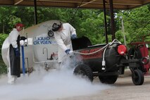 U.S. Air Force Airman 1st Class Charles Jones (left) and Staff Sgt. Jeremy Varney transfer liquid oxygen from a 600-gallon tank to a 50-gallon cart on Seymour Johnson Air Force Base, N.C., April 25, 2012. Liquid oxygen is utilized on F-15E Strike Eagles, giving pilots the ability to breathe at high altitudes. Jones, 4th Logistics Readiness Squadron fuels distribution operator, is from Panama City, Fla. Varney, 4th LRS facilities supervisor, hails from Biloxi, Miss. (U.S. Air Force photo/Airman 1st Class John Nieves Camacho/Released)
