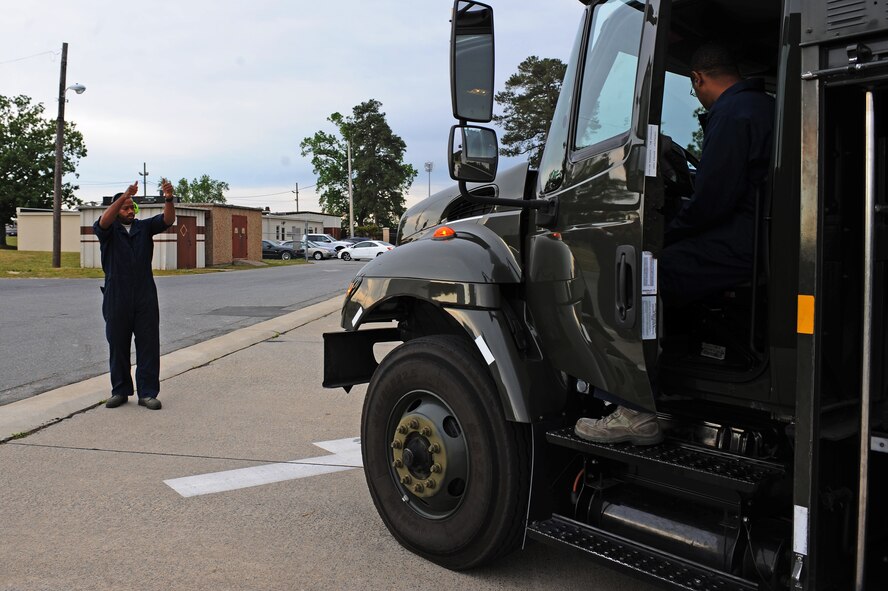 U.S. Air Force Staff Sgt. Rodney Hunter signals confirmation of operational lights on an R-11 refueling truck to Staff Sgt. Dorell Pettus on Seymour Johnson Air Force Base, N.C., April 25, 2012. Preventive maintenance personnel must check lights, engine and fuel levels daily to ensure service is not needed. Hunter, 4th Logistics Readiness Squadron refueling maintenance supervisor, hails from Enfield, N.C. Pettus, 4th LRS fuels refueling maintenance supervisor, is from Charlotte, N.C. (U.S. Air Force photo/Airman 1st Class John Nieves Camacho/Released)
