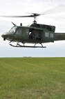 MINOT AIR FORCE BASE, N.D. -- Senior Airman Dan Vehslage, 54th Helicopter Squadron flight engineer, ensures the UH-1N Huey is clear for take-off here April 26. Helicopters can transport security forces and guard missile convoys transporting equipment or tactically insert members anywhere throughout the plains to react to security situations at missile complexes. (U.S. Air Force photo/Senior Airman Brittany Y. Auld)