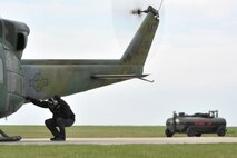 MINOT AIR FORCE BASE, N.D. -- A mechanic from the 54th Helicopter Squadron, performs a pre-flight inspection on a UH-1N helicopter here April 26. The 54th HS allows the Air Force to respond quickly and effectively to emergency situations in a timely manner. (U.S. Air Force photo/Senior Airman Brittany Y. Auld)