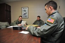 MINOT AIR FORCE BASE, N.D. -- Capt. Lee Humphries, 54th Helicopter Squadron pilot, briefs 1st Lt. Brian Hickner, 54th HS pilot, and Senior Airman Daniel Vehslage, 54th HS flight engineer, on their flying mission here April 26. The 54th HS’s primary mission is to support the 91st Missile Wing with highly skilled pilots and flight engineers with well-maintained UH-1N Huey to respond as necessary to ensure missile complexes scattered throughout North Dakota are safe and secure. (U.S. Air Force photo/Senior Airman Brittany Y. Auld) 