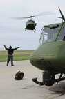MINOT AIR FORCE BASE, N.D. -- A mechanic from the 54th Helicopter Squadron, guides a UH-1N Huey to the landing pad here April 26. The 54th HS’s primary mission is to support the 91st Missile Wing with highly skilled pilots and flight engineers with well-maintained UH-1N Hueys to respond as necessary to ensure missile complexes scattered through North Dakota are safe and secure. (U.S. Air Force photo/Senior Airman Brittany Y. Auld)