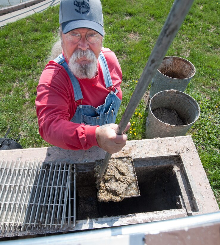 Chuck Hand, Project Solutions Inc. manager for the base’s waste water treatment facility, uses a dipper to remove grease from the distribution box treatment at Ellsworth Air Force Base, S.D., April 26, 2012. Food, grease, and other chemicals or solvents should ever be poured down sink drains--this can create blockages and other issues. (U.S. Air Force photo by Airman 1st Class Alystria Maurer/Released)