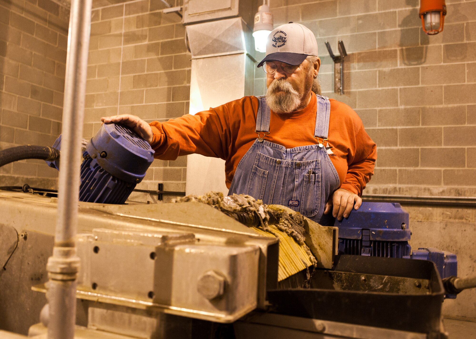 Chuck Hand, Project Solutions Inc. manager for the base’s waste water treatment facility, watches as a step screen sorts through solids found in waste water during water treatment at Ellsworth Air Force Base, S.D., April 26, 2012. When non-soluble waste is flushed down toilets they must be processed out of the water, creating extra work for members of the waste water treatment facility. (U.S. Air Force photo by Airman 1st Class Alystria Maurer/Released)
