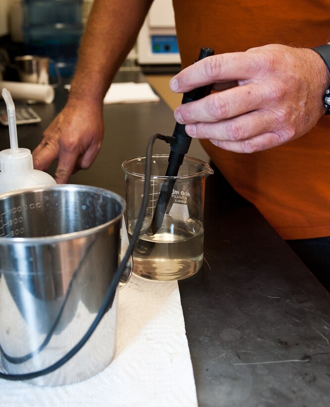 Carl Johnson, Project Solutions Inc. lab technician and water treatment operator, tests the pH levels of a water sample during routine water tests at the waste water treatment facility on Ellsworth Air Force Base, S.D., April 26, 2012. The Ellsworth waste water treatment facility treats approximately 800,000 gallons of water a day. Before the water is legally allowed to go into the public system, the Ph levels must be neutral. (U.S. Air Force photo by Airman 1st Class Alystria Maurer/Released)
