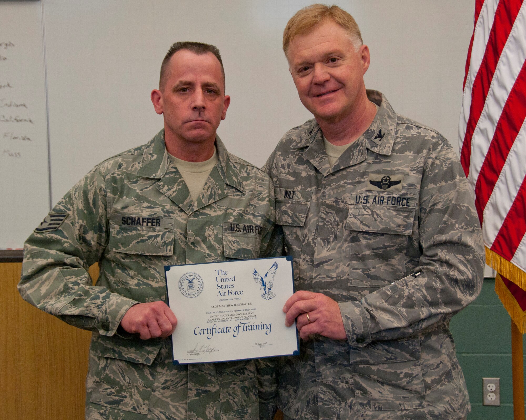 Colonel Ronald A. Wilt, commander of the 934th Airlift Wing Operations Group, presents a graduation certificate to Staff Sergeant Matthew Schaffer of the 934th Aeromedical Staging Squadron for his completion of the Leadership Development Course, March 27, 2012. (US Air Force Photo/ Tech Sgt Jim Loehr)