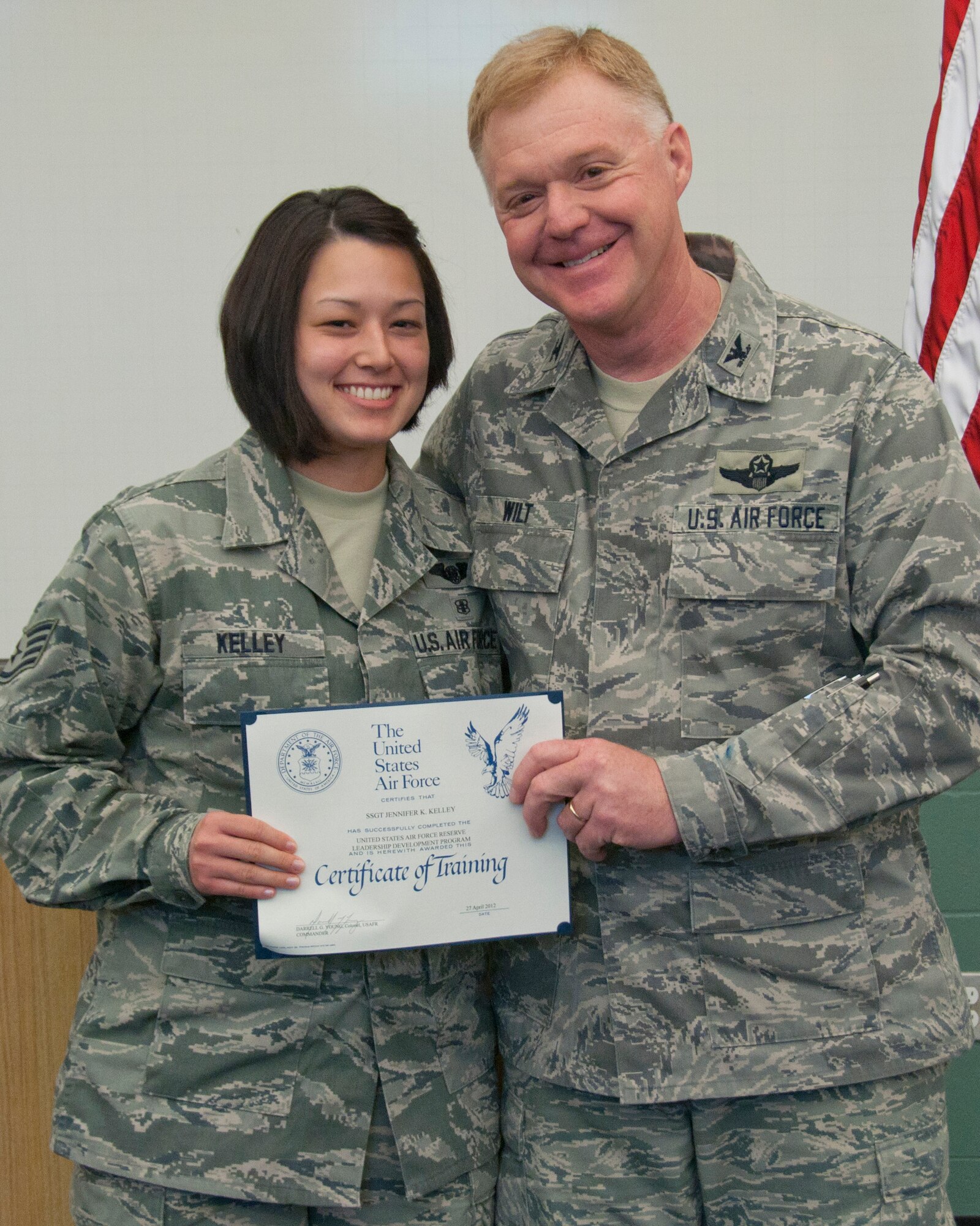 Colonel Ronald A. Wilt, commander of the 934th Airlift Wing Operations Group, presents a graduation certificate to Staff Sergeant Jennifer Kelley of the 934th Aeromedical Evacuation Squadron for her completion of the Leadership Development Course, March 27, 2012. (US Air Force Photo/ Tech Sgt Jim Loehr)