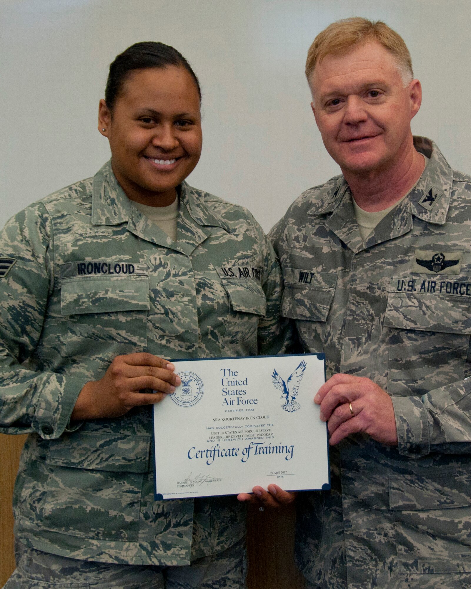 Colonel Ronald A. Wilt, commander of the 934th Airlift Wing Operations Group, presents a graduation certificate to Senior Airman Kourtenay Ironcloud of the 934th Airlift Wing Maintenance Operations Flight  for her completion of the Leadership Development Course, March 27, 2012. (US Air Force Photo/ Tech Sgt Jim Loehr)