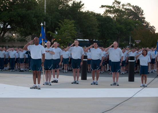 Members of the 23d Maintenance Group, leadership and distinguished visitor Maj. Gen. Mark Atkinson, Air Combat Command director of logistics, salute during the playing of Reveille in front of the George W. Bush Air Park at Moody Field April 27, 2012, at Moody Air Force Base, Ga.  Atkinson was the guest speaker for the Maintenance Professional of the Year banquet the night prior and participated in the 23d MXG Sports Day formation run before his departure from the base. (U.S. Air Force photo by Senior Airman Eileen Meier/Released)