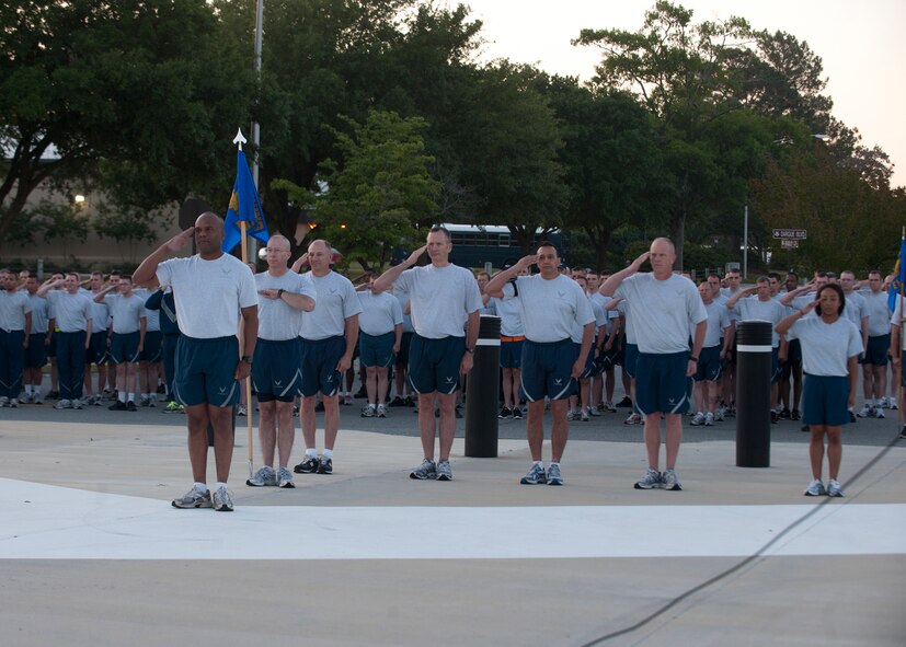 Members of the 23d Maintenance Group, leadership and distinguished visitor Maj. Gen. Mark Atkinson, Air Combat Command director of logistics, salute during the playing of Reveille in front of the George W. Bush Air Park at Moody Field April 27, 2012, at Moody Air Force Base, Ga.  Atkinson was the guest speaker for the Maintenance Professional of the Year banquet the night prior and participated in the 23d MXG Sports Day formation run before his departure from the base. (U.S. Air Force photo by Senior Airman Eileen Meier/Released)