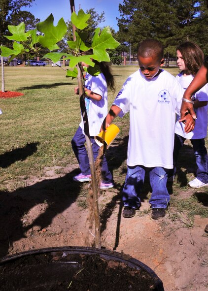 Demend Mekhi Maul, son of Tech. Sgt Nicole Maul, 23d Medical Group, helps plant a tree at the Tree City USA Park at Moody Air Force Base, Ga., April 27, 2012. Every year Moody celebrates Arbor Day by planting a native tree that will flourish. This year’s tree was a yellow poplar.  (U.S. Air Force photo by Staff Sgt. Stephanie Mancha/Released)
