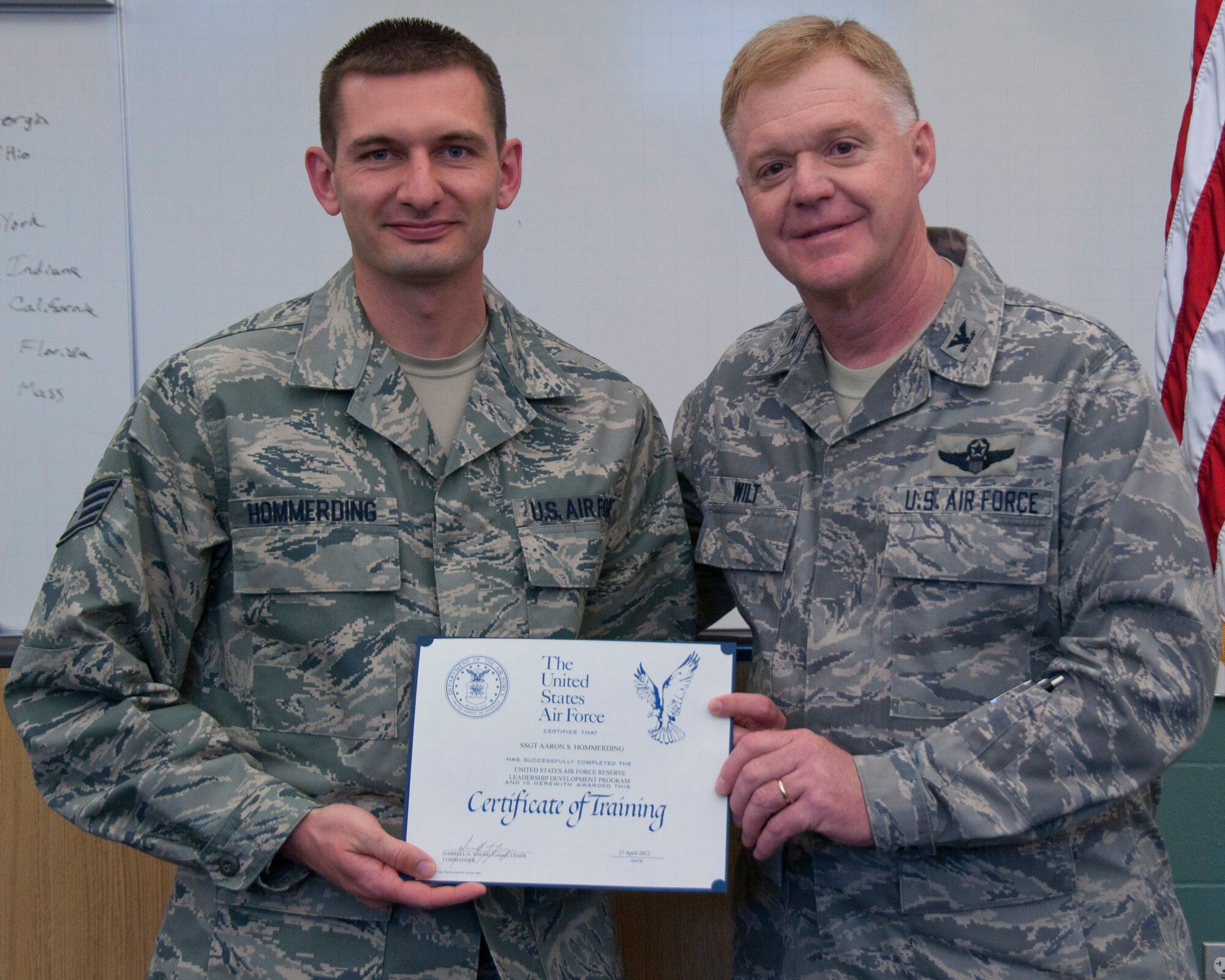 Colonel Ronald A. Wilt, commander of the 934th Airlift Wing Operations Group, presents a graduation certificate to Staff Sergeant Aaron Hommerding of the 934th Aeromedical Staging Squadron for his completion of the Leadership Development Course, March 27, 2012. (US Air Force Photo/ Tech Sgt Jim Loehr)