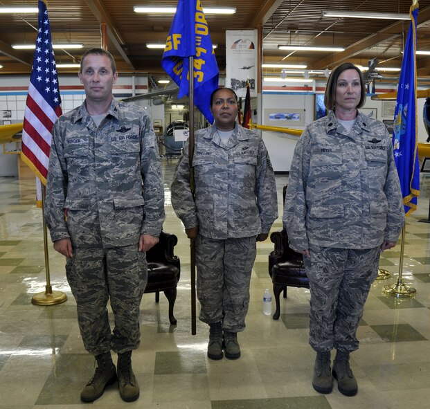 TRAVIS AIR FORCE BASE, Calif. -- Lt. Col. Ruth Meyer (right), 349th Operations Support Flight commander, accepts the guidon from Col. Matthew Burger, 349th Operations Group commander, during an assumption of command ceremony at Travis Air Force Base, Calif., on April 22, 2012. The passing of the guidon symbolizes a new commander assuming his or her duties as the leader of an organizational unit. (U.S. Air Force photo/Tech. Sgt. Rachel Martinez)