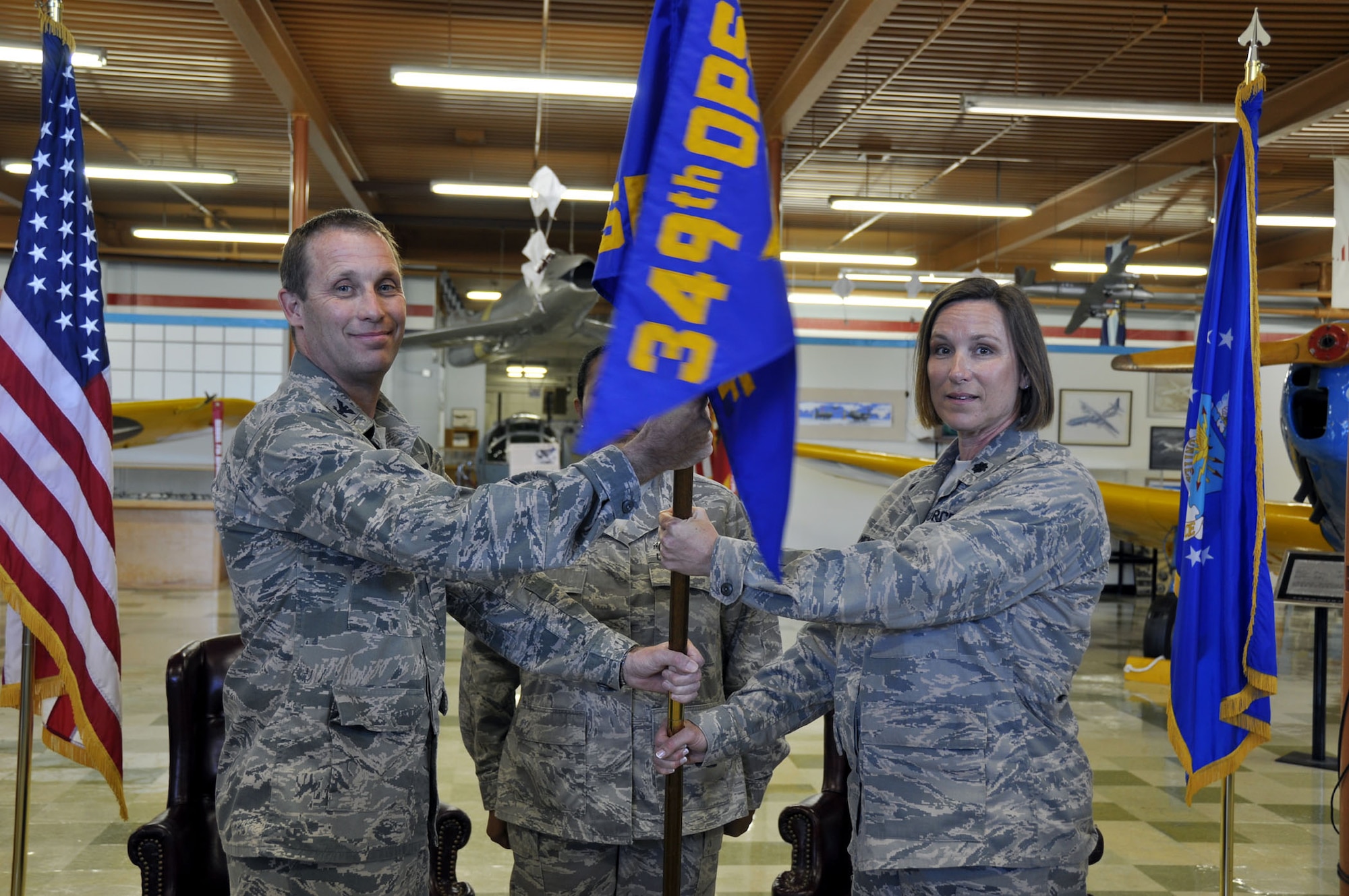 TRAVIS AIR FORCE BASE, Calif. -- Lt. Col. Ruth Meyer (right), 349th Operations Support Flight commander, accepts the guidon from Col. Matthew Burger, 349th Operations Group commander, during an assumption of command ceremony at Travis Air Force Base, Calif., on April 22, 2012. The passing of the guidon symbolizes a new commander assuming his or her duties as the leader of an organizational unit. (U.S. Air Force photo/Tech. Sgt. Rachel Martinez)