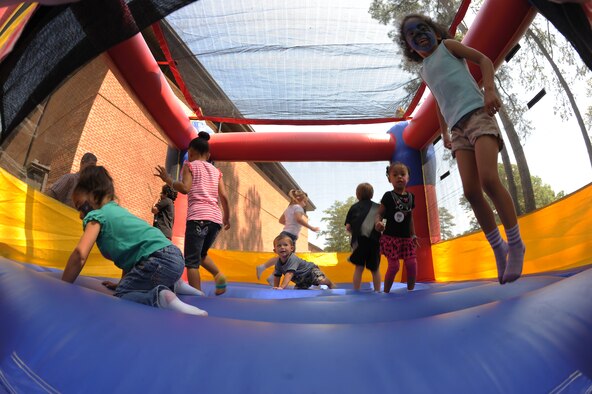 Military dependants play inside a bounce house during the Month of the Military Child information fair on Seymour Johnson Air Force Base, N.C., April 21, 2012. In 1986, former Secretary of Defense Casper Weinberg designated April as the Month of the Military Child for the sacrifices they make in support of our Nation's freedoms. (U.S. Air Force photo/Airman 1st Class John Nieves Camacho/Released)