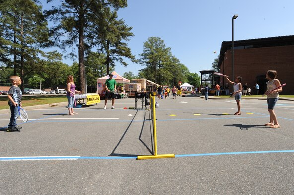 Children of service members play tennis during the Month of the Military Child information fair on Seymour Johnson Air Force Base, N.C., April 21, 2012. Participants also jumped in a bounce house, rode horses, and played corn hole. (U.S. Air Force photo/Airman 1st Class John Nieves Camacho/Released)