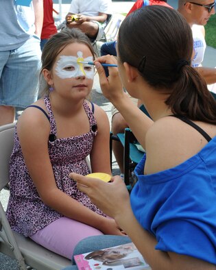 U.S. Air Force Staff Sgt. Kim Walton paints a design on Sydney Abendschoen, 8, during the Month of the Military Child information fair on Seymour Johnson Air Force Base, N.C., April 21, 2012. During the fair, there were three volunteer face painters who created hundreds of designs on kid’s faces. Walton, 4th Security Forces Squadron unit trainer, is from Stockton, Calif. Sydney is the daughter of Master Sgt. Kevin Abendschoen a 4th Security Forces Squadron evaluator from New Freedom, Pa. (U.S. Air Force photo/Airman 1st Class John Nieves Camacho/Released)