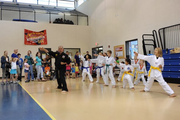 Ed Brosseau leads his students in a martial arts drill during the Month of Military Child information fair at the youth center on Seymour Johnson Air Force Base, N.C., April 21, 2012. Brosseau and his students demonstrated traditional Korean martial arts for spectators. Brosseau is the Goldsboro Elite Martial Arts Academy head instructor. (U.S. Air Force photo/Airman 1st Class John Nieves Camacho/Released)