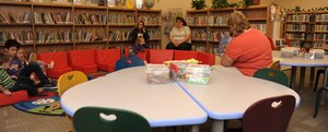 Children and parents watch on as Lori Urfer, 366th Force Support Squadron senior librarian technician, reads to children during story time at Mountain Home Air Force Base, Idaho, April 26, 2012. The library also offers other programs such as book club and a youth summer reading program. (U.S. Air Force photo/Airman 1st Class Jonathan Glanville)
	

